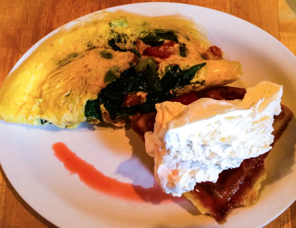 Made-to-order omelette and Belgian waffle topped with strawberries and a huge dollop of whipped cream at Hofbrau's Sunday brunch. (Photo by Erin Klema)