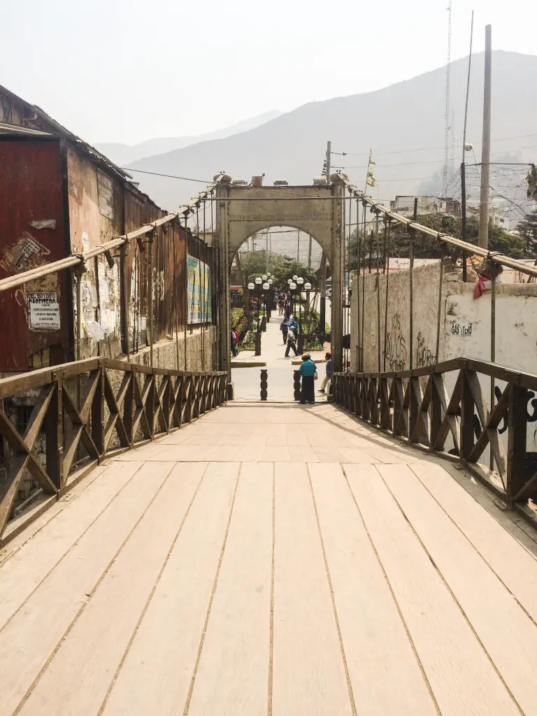 A pedestrian bridge spanning the Rímac River leads to the shops and parks of Chosica, Peru. | The Epicurean Traveler