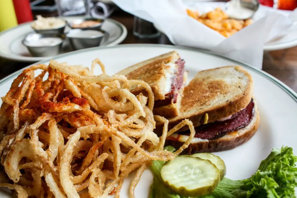 Grilled Jim's Blue Ribbon summer sausage topped with a brown mustard, Muenster cheese, and shaved red onions on rye bread at The Old Fashioned in downtown Madison, Wisconsin. (Erin Klema/The Epicurean Traveler)