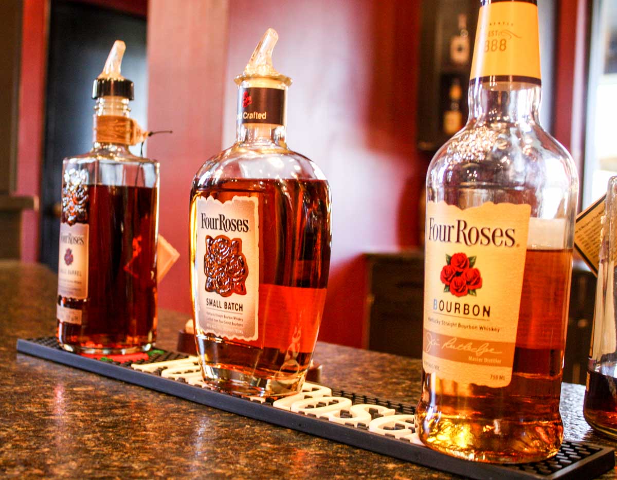 Three Four Roses bourbon bottles lined up for a bourbon tasting