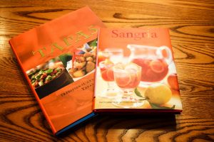 Tapas and Sangria cookbooks on wooden dining table