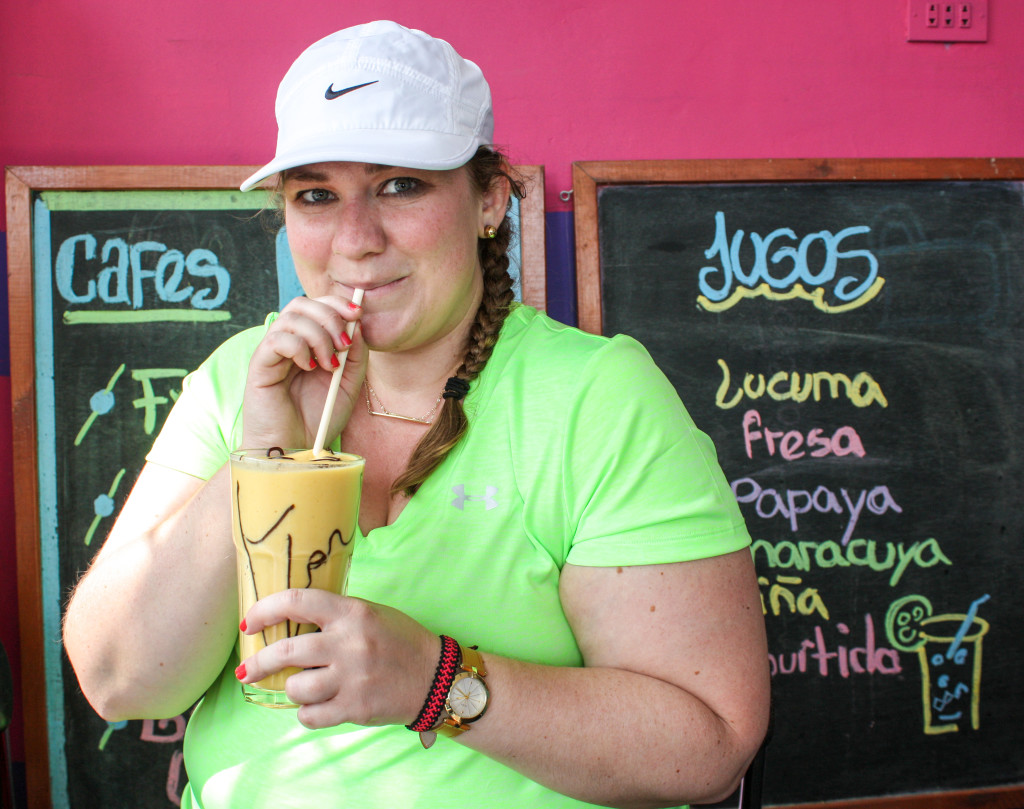 Female traveler drinks mango smoothie at a juice bar and cafe in Chosica, Peru | The Epicurean Traveler