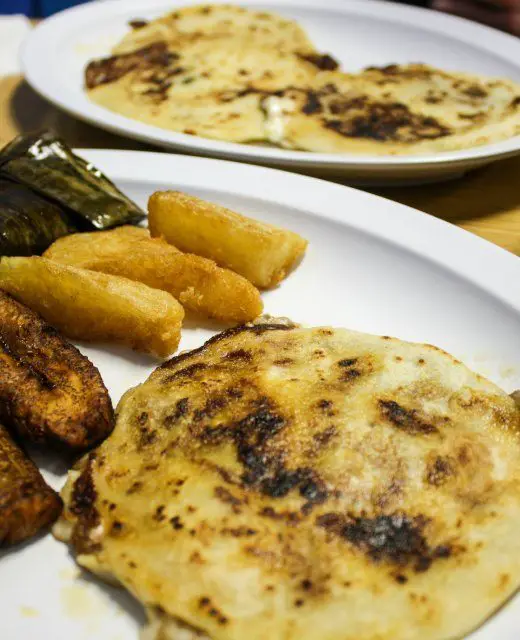 Pupuseria El Salvador pupusas, yuca fritas, tamale, and fried plantains