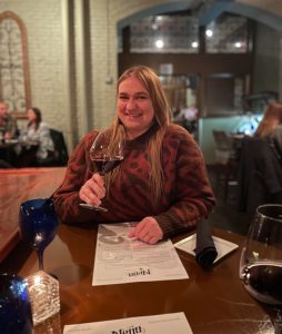 A woman holds a glass of red wine at Divani, a romantic resturant in downtown Grand Rapids, Michigan, USA