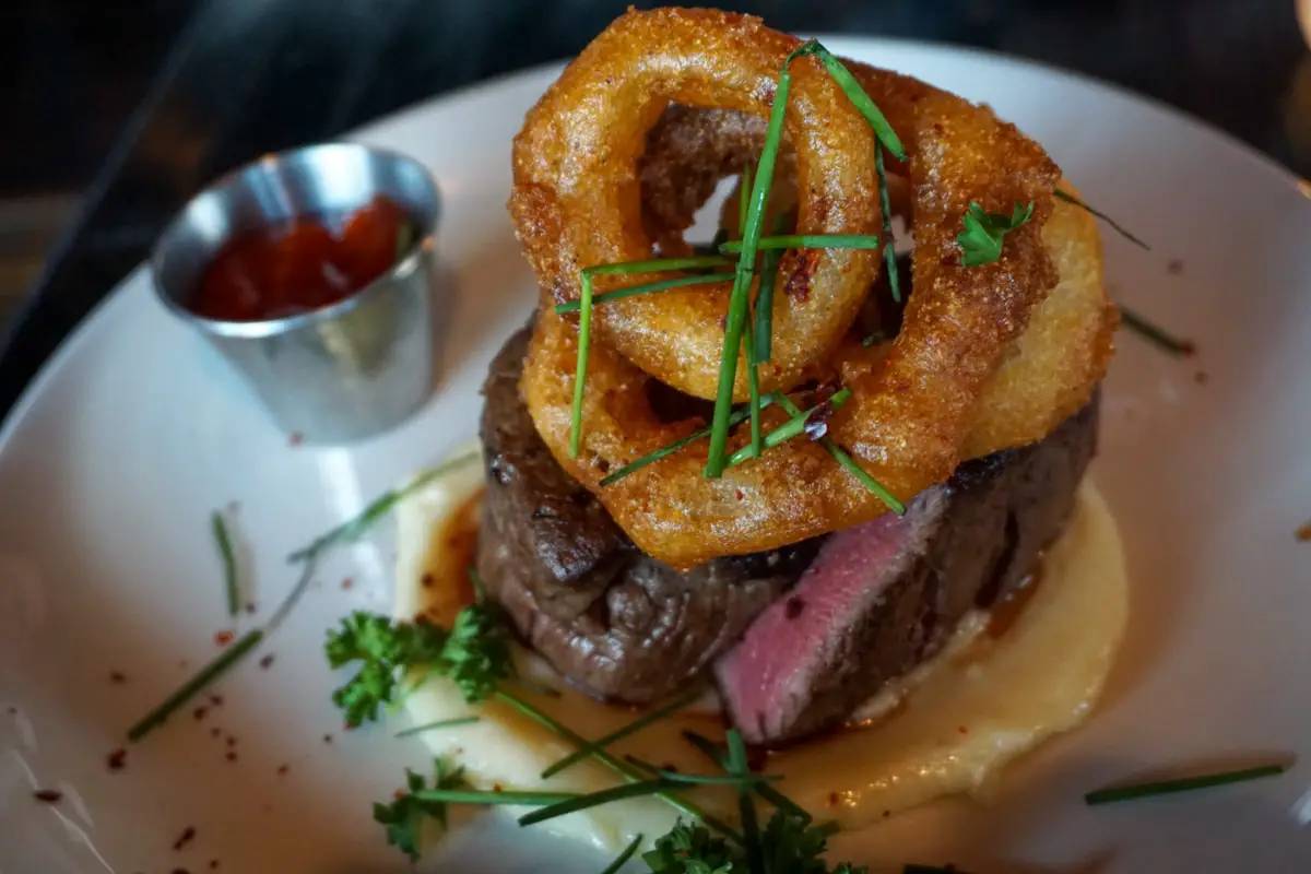 Filet mignon topped with onion rings at Grey Ghost Detroit circa May 2018