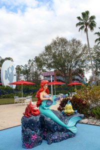 A statue of Disney's "The Little Mermaid" characters Sebastian, Ariel, and Flounder at Disney's All-Star Music Resort on the Walt Disney World Resort property in Lake Buena Vista, Florida, near Orlando