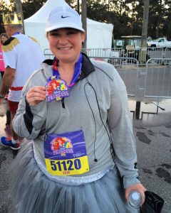 5K participant holds up her medal after the Disney Princess 5K at Walt Disney World near Orlando, Florida