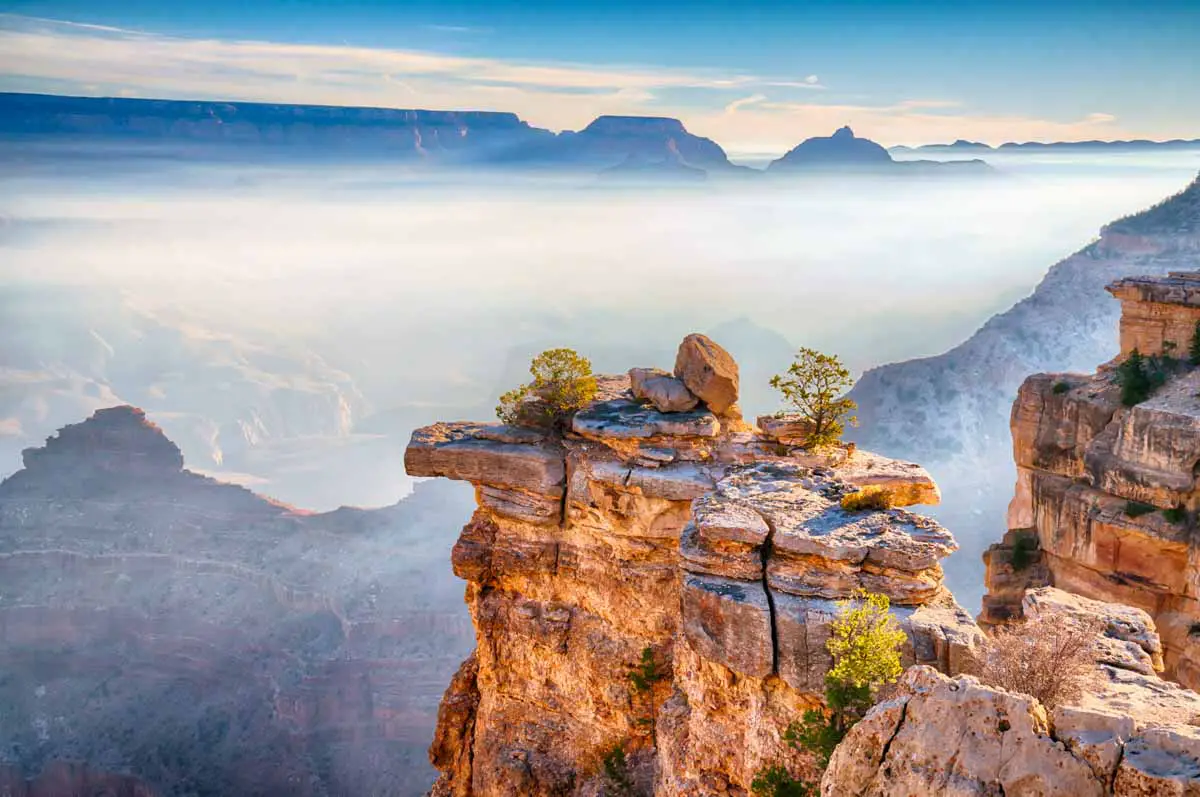 Rays of sunlight cross the morning fog in the Grand Canyon from the South Rim