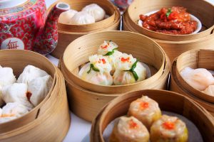Variety of dim sum in bamboo baskets at yum cha