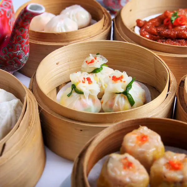 Variety of dim sum in bamboo baskets at yum cha