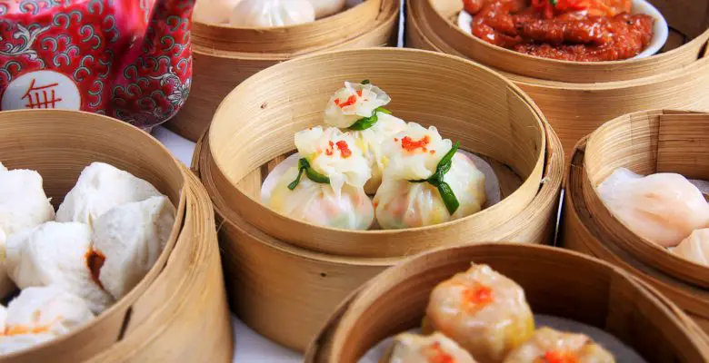 Variety of dim sum in bamboo baskets at yum cha