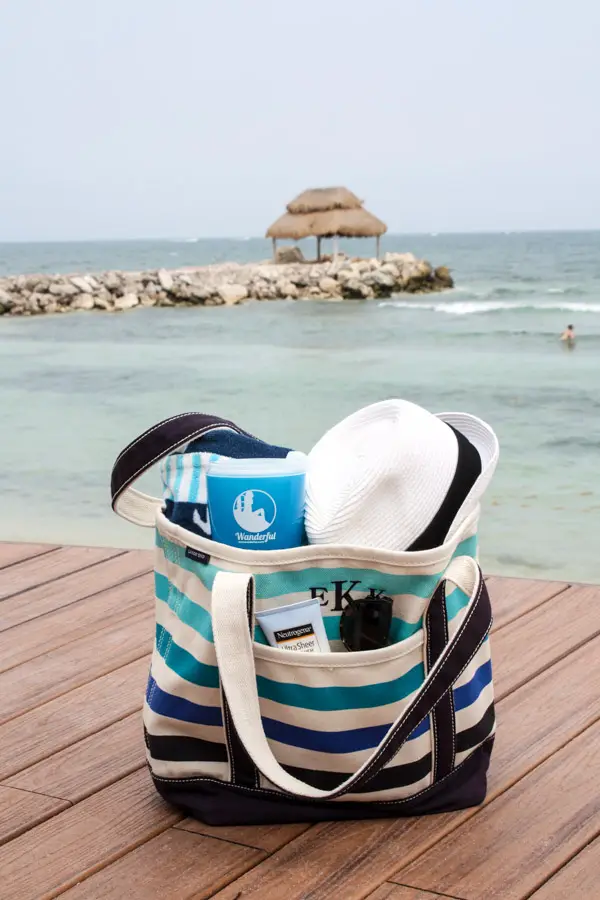 Lands' End tote bag filled with beach and pool day essentials at an all-inclusive beachfront resort in the Riviera Maya, Mexico
