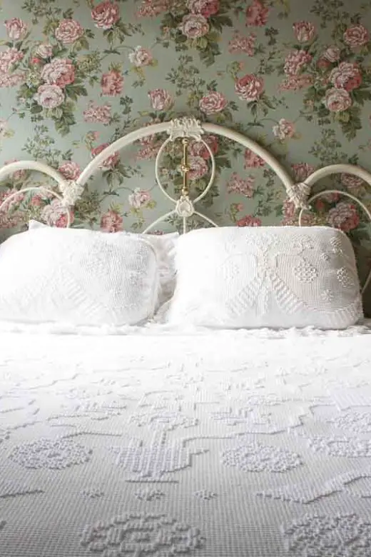 Guest room bed with bedside lamps in the historic Hotel Boulderado in Boulder, Colorado
