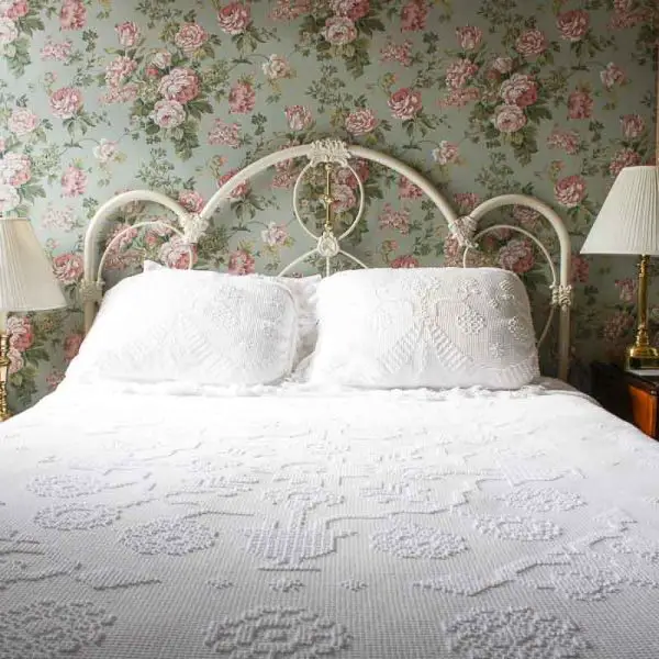 Guest room bed with bedside lamps in the historic Hotel Boulderado in Boulder, Colorado
