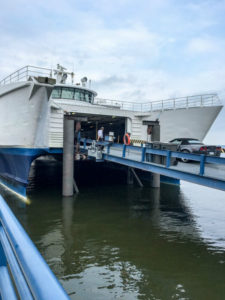 A driver drives his car onto the Lake Express
