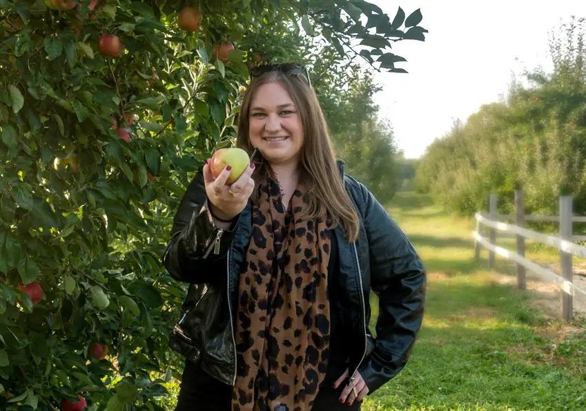 Erin holds an apple picked at Robinette's Apple Haus & Winery in Grand Rapids, Michigan