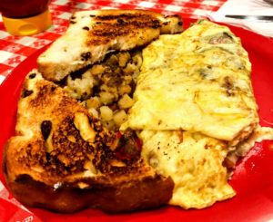 Sunshine Omelette with American Fries and Cinnamon Raisin Toast at Studio Grill in Kalamazoo, Michigan