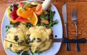 Eggs Benny with fresh fruit at the Blue Fox Cafe in Victoria, British Columbia, Canada