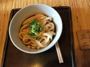 Udon, a Japanese specialty rice noodle with umami soupbase and scallion.