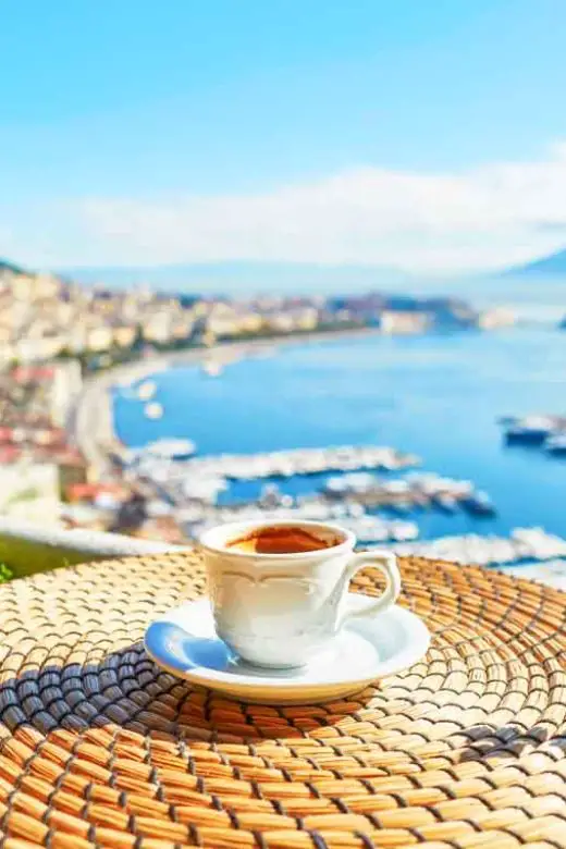 Cup of fresh espresso coffee in a cafe with a view of Mount Vesuvius in Naples, Campania, Southern Italy