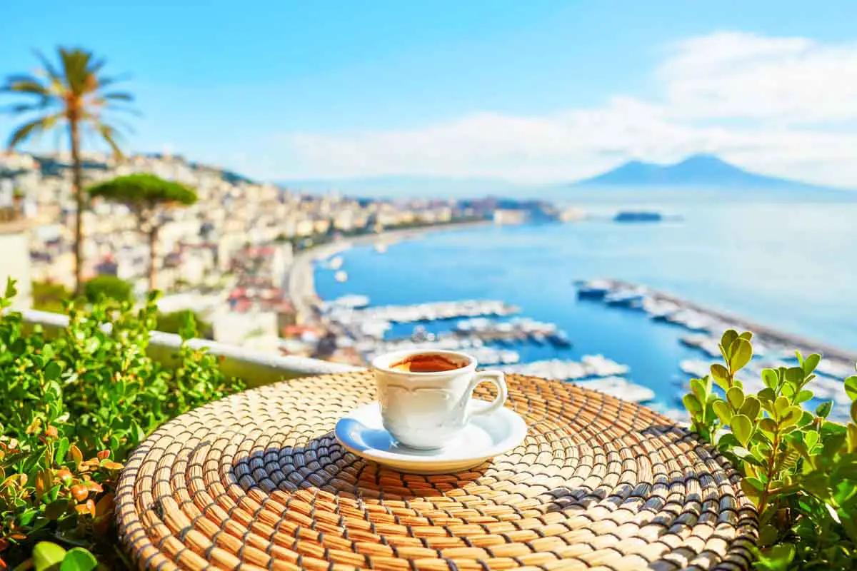 Cup of fresh espresso coffee in a cafe with a view of Mount Vesuvius in Naples, Campania, Southern Italy