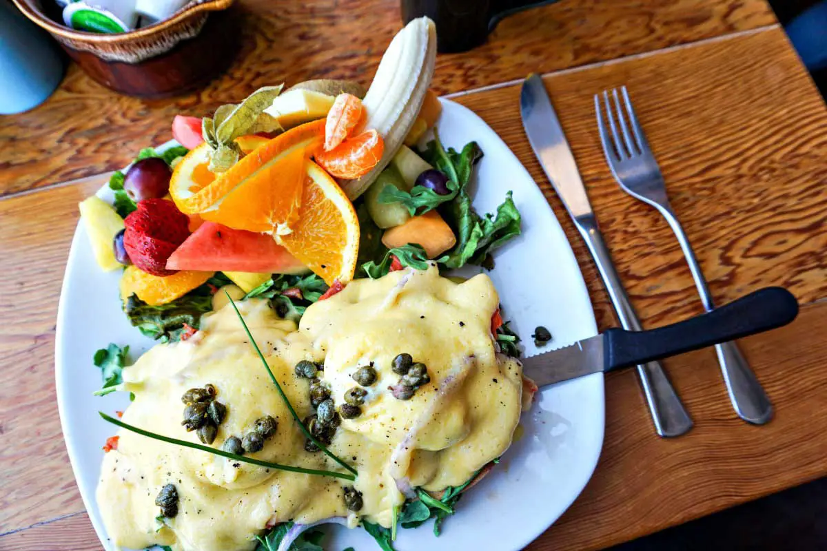 Eggs Benedict with mixed fruit at Blue Fox Cafe in Victoria, British Columbia, Canada