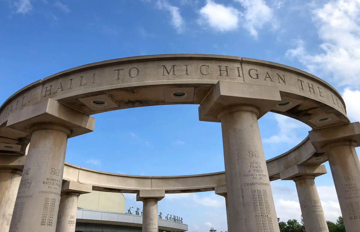 Circle of Champions (Varsity Colonnade) monument inside the gates of Michigan Stadium with Crisler Center in the background at the University of Michigan in Ann Arbor, Michigan, USA