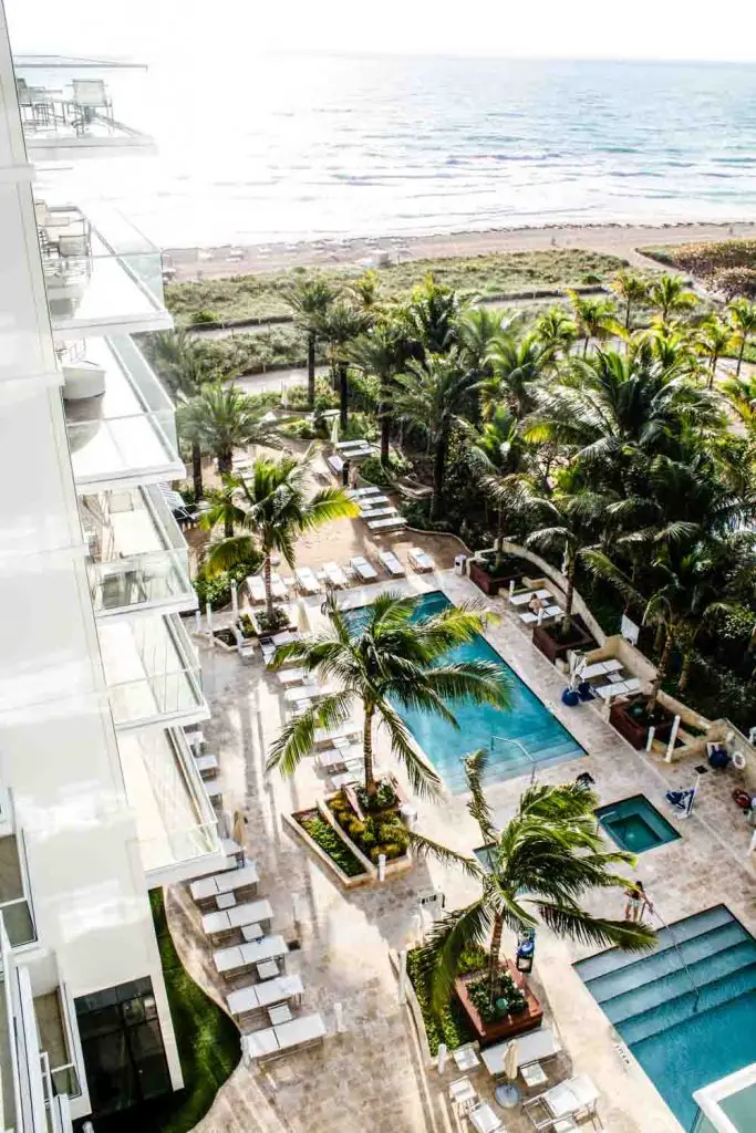 View of pools, beach, and ocean from Grand Beach Hotel Surfside guest room balcony