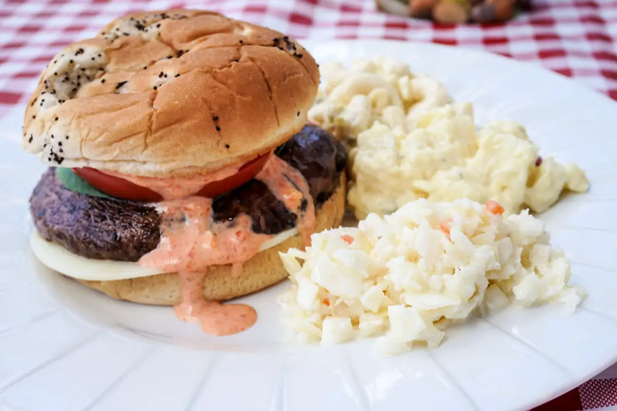 Portobello Mushroom Burger with Red Pepper Aioli served alongside Reser's Fine Foods deli salads for a meatless barbecue meal