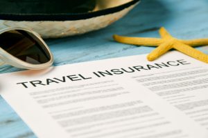 Travel Insurance Policy with straw hat, sunglasses, and starfish