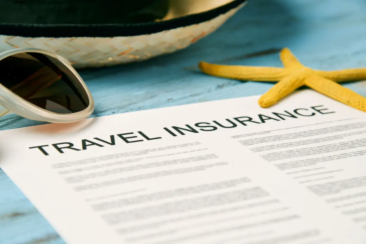 Travel Insurance Policy with straw hat, sunglasses, and starfish