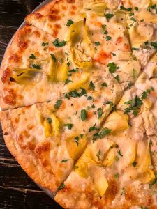 Thin-crust pizza with artichoke, lemon, and garlic at Eduardo's Enoteca in Chicago's Gold Coast neighborhood