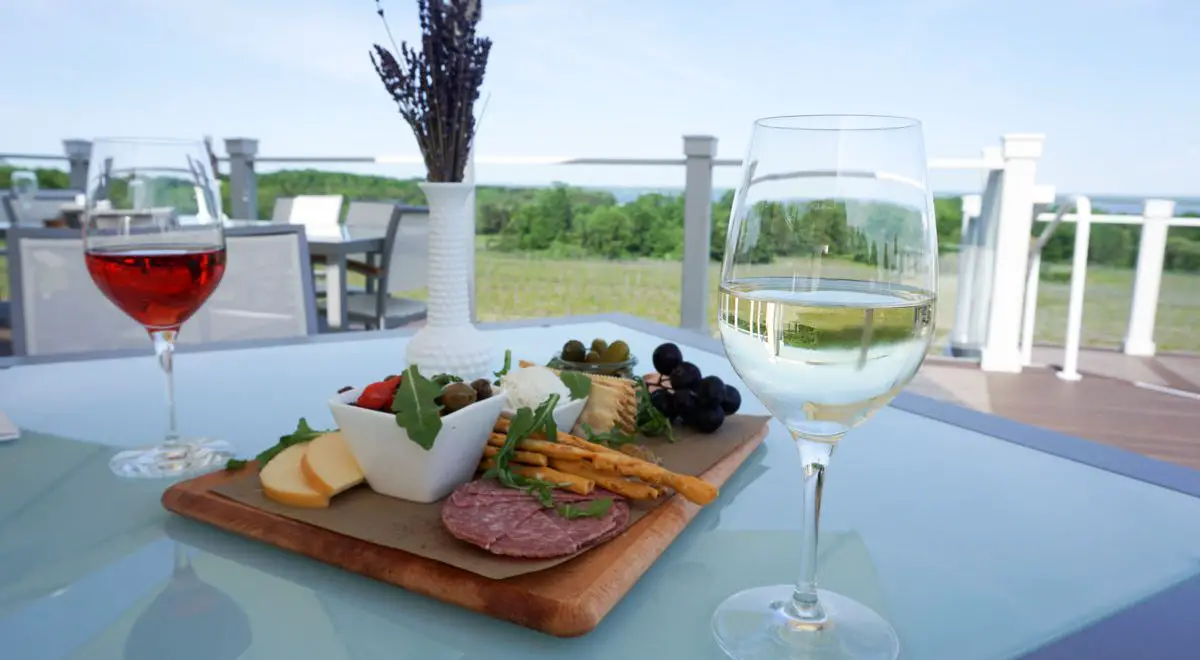 Glasses of Rosé and Dry Riesling white wine with a charcuterie board and vase of freshly picked lavender on the upper deck of Brys Estate Vineyard & Winery on Old Mission Peninsula, Traverse City, Michigan