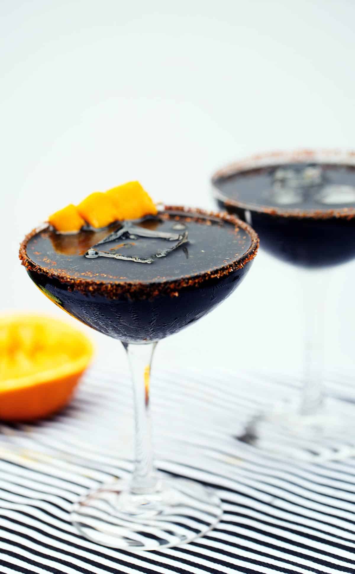 Midnight mango margaritas Halloween cocktail with activated charcoal powder