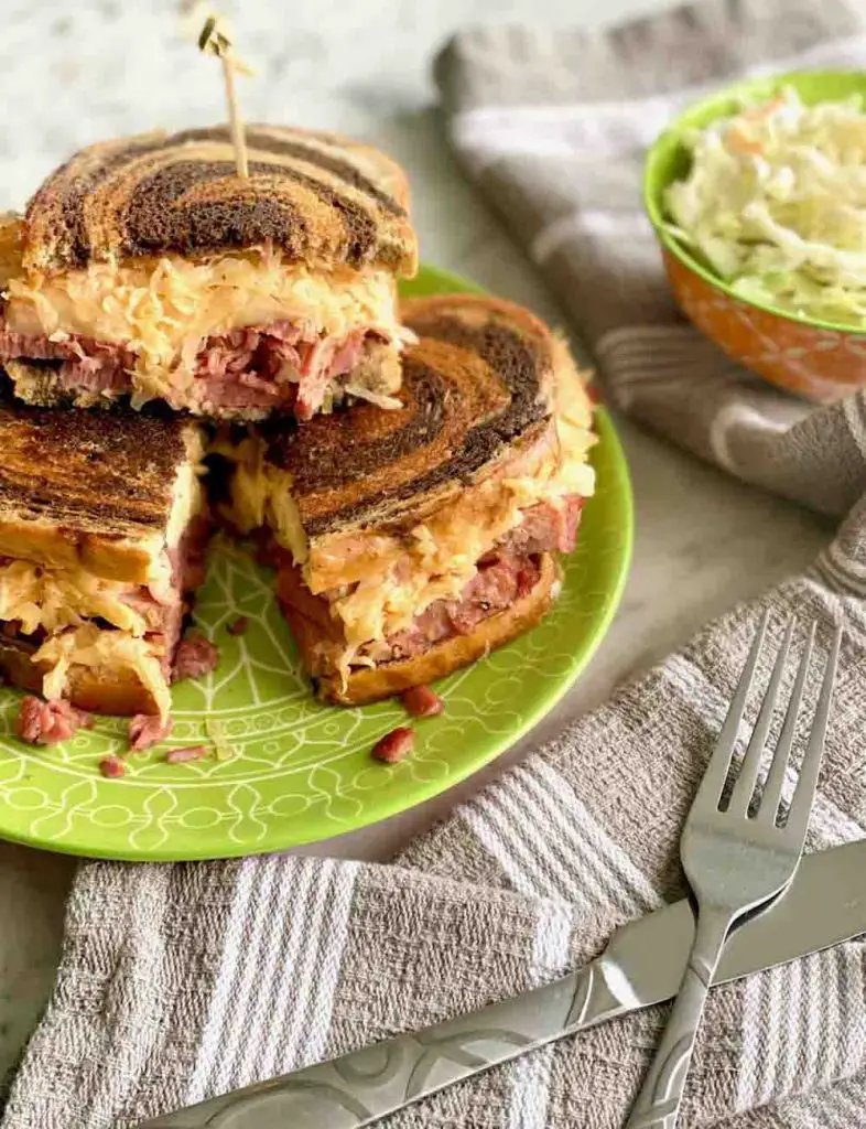 Reuben sandwiches on green plate