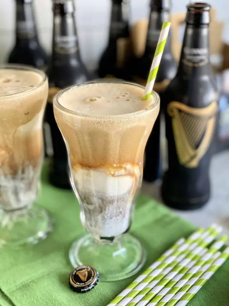 Guinness floats served in ice-cream glasses with green-and-white straws