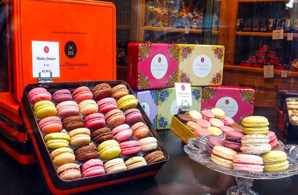 French macarons displayed in shop window in Paris, France