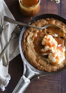 Baileys Irish Cream chocolate-chip cookie skillet topped with salted caramel whiskey sauce