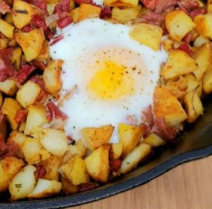Close-up of corned beef hash skillet with shirred egg