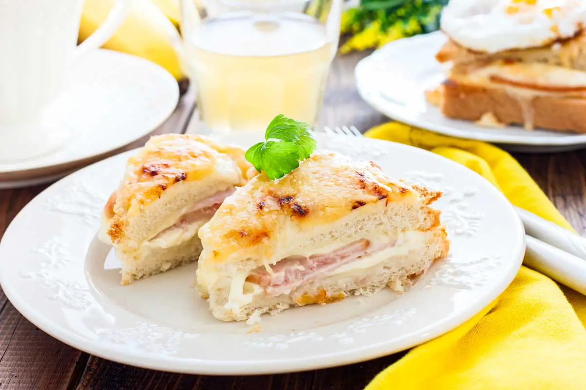 Croque Monsieur sandwich on a white plate in breakfast setting