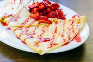 French crepe with strawberries and whipped cream