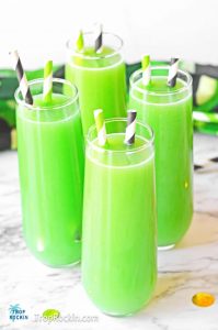 Four green mimosas in stemless champagne flutes with striped straws