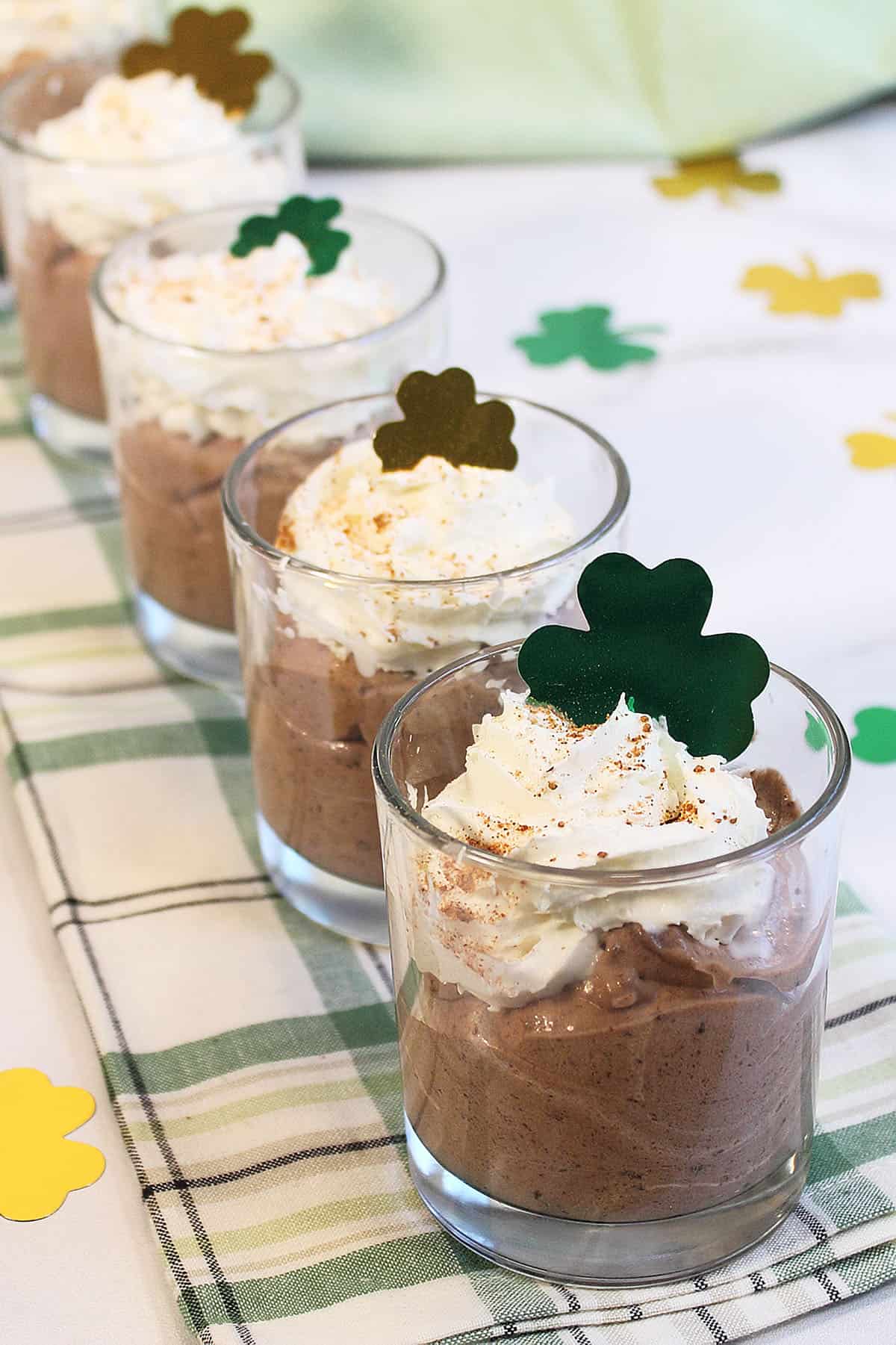 Irish coffee mousse desserts lined up on green plaid towel