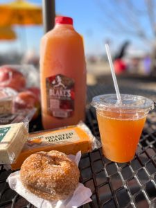 Spread of apple cider, cinnamon sugar doughnut, assorted cheeses, and fresh apples at Blake's Orchard & Cider Mill