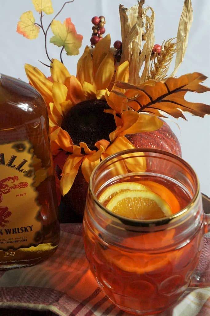 Fireball and Red Hots spiced apple cider cocktail in fall setting