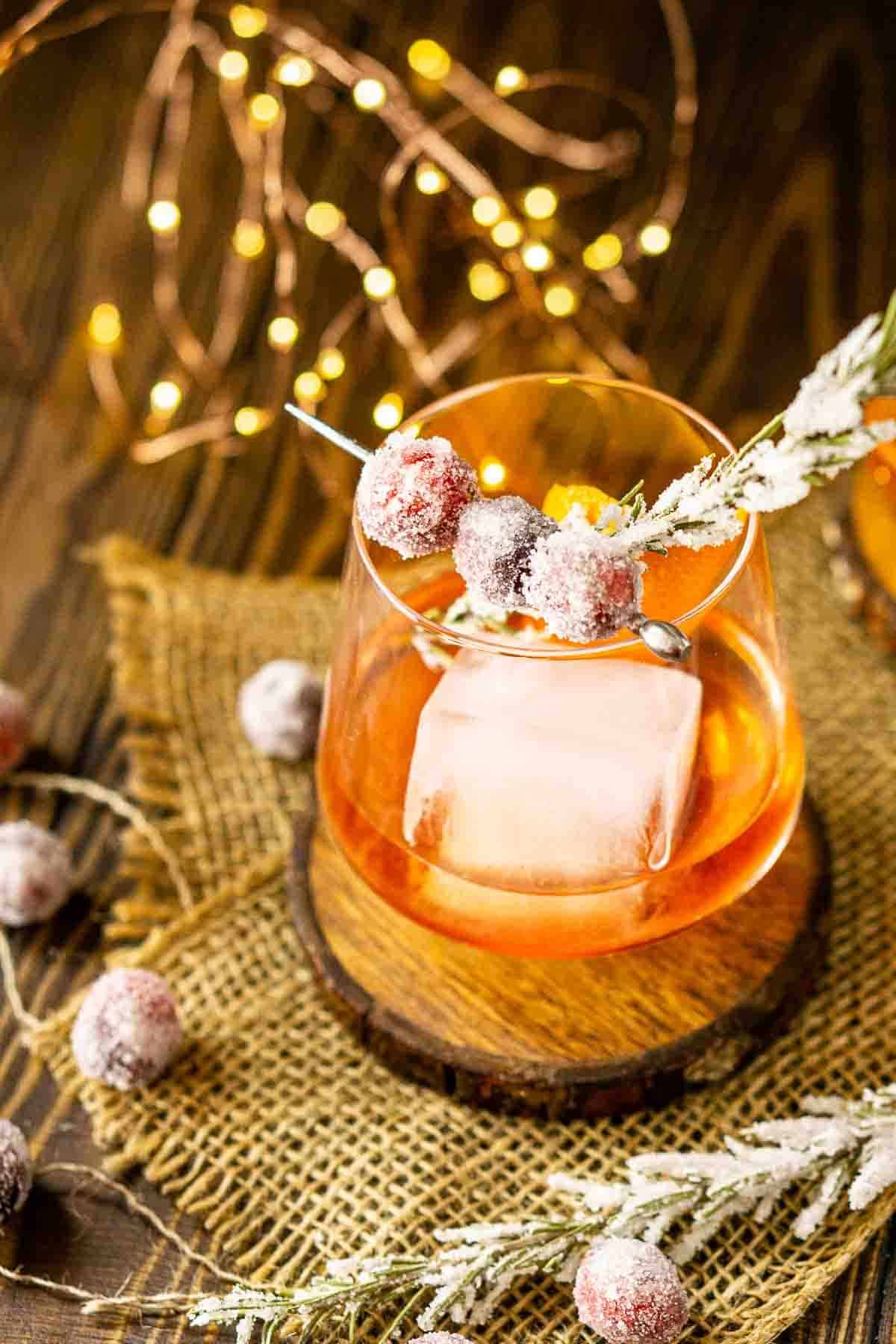 Spiced cranberry old fashioned cocktail with sugared cranberries garnish