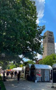 Ann Arbor Art Fair artists' booths line the streets of Ann Arbor, Michigan, near the Burton Memorial Tower on the University of Michigan campus