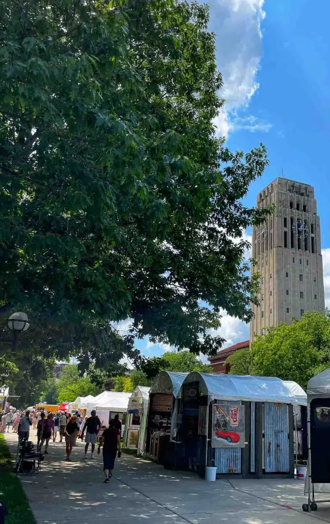 Ann Arbor Art Fair artists' booths line the streets of Ann Arbor, Michigan, near the Burton Memorial Tower on the University of Michigan campus