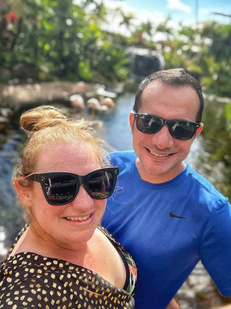 Honeymooning couple wearing sunglasses poses for a selfie in front of the flamingos at the Westin Maui Resort & Spa, Ka'anapali