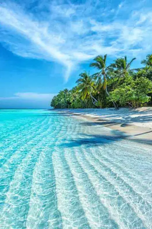 Seculded white-sand beach with clear water in the Maldives, tropical islands in South Asia